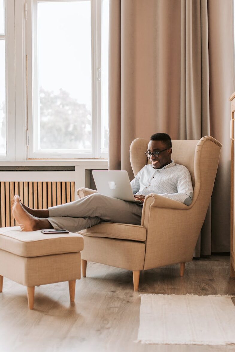 man relaxing and working on his laptop